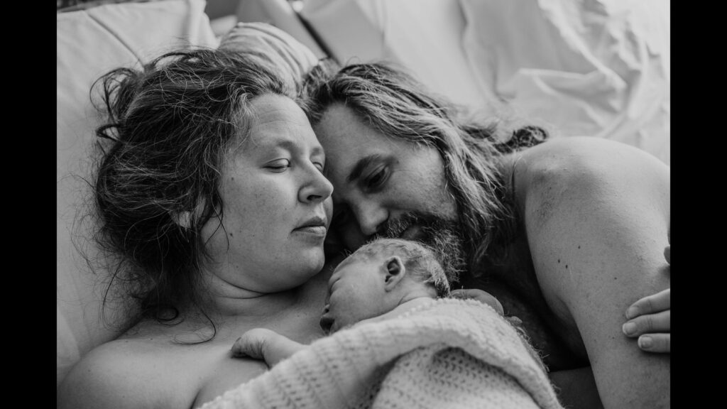 Father and mother with their baby grieving